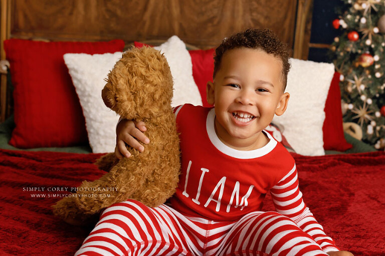 mini session photographer near Villa Rica, child laughing in Christmas pajamas