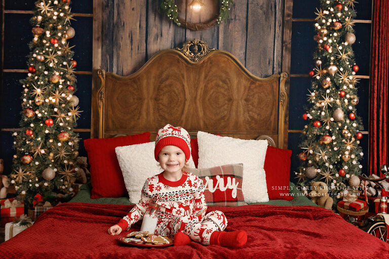 Carrollton mini session photographer in GA, child in Christmas pajamas and hat with milk and cookies