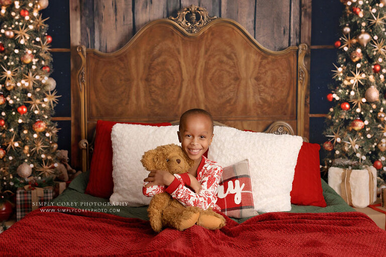 mini session photographer near Douglasville, child in Christmas pajamas with teddy bear