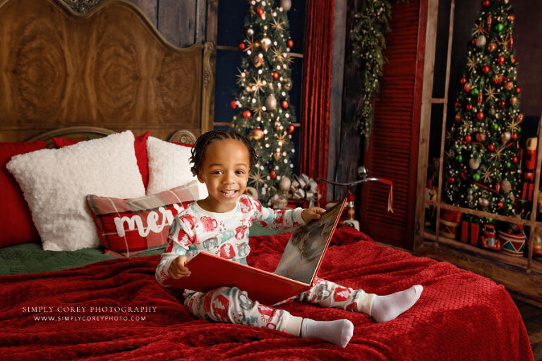 Villa Rica mini session photographer, child in Christmas pajamas with book