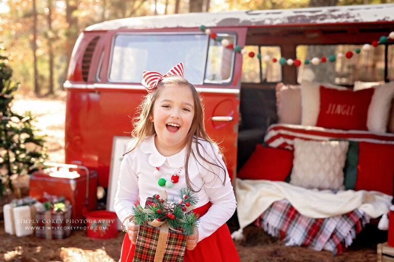 mini session photographer near Peachtree City, child laughing outside with Christmas VW Bus set
