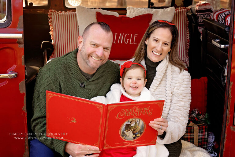 Tallapoosa family photographer, reading Christmas book to baby during VW bus mini session