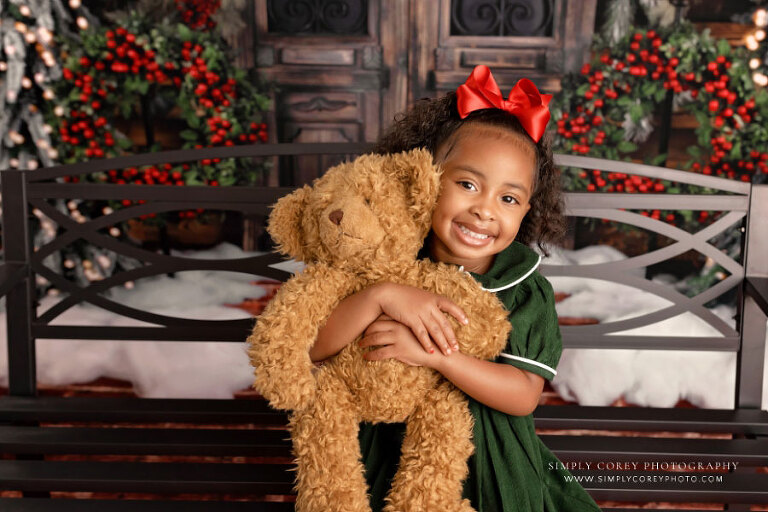 Atlanta Christmas mini session photographer, child hugging teddy bear