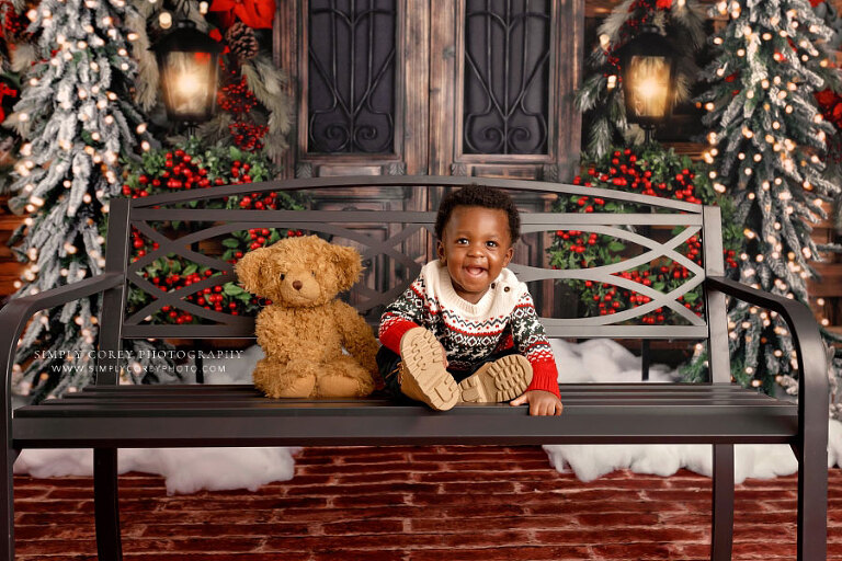Carrollton mini session photographer in GA, baby with teddy bear on Christmas studio set
