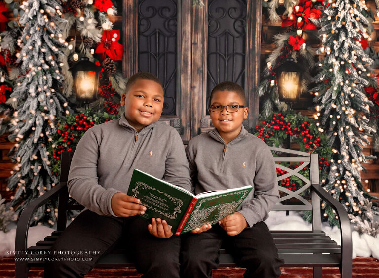 mini session photographer near Carrollton, GA; children with Christmas book on studio set