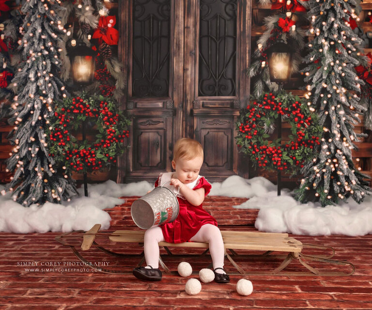 mini session photographer near Dallas, GA; baby on Christmas set with snowballs