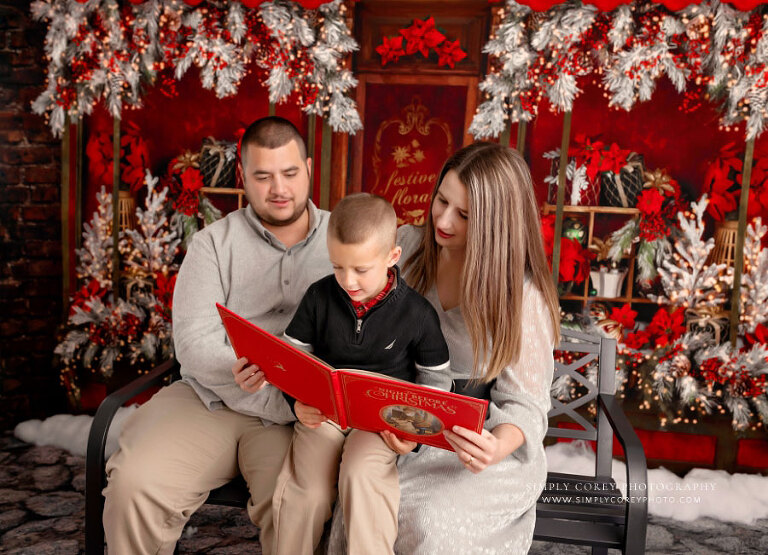 West Georgia mini session photographer, family reading Christmas book on bench