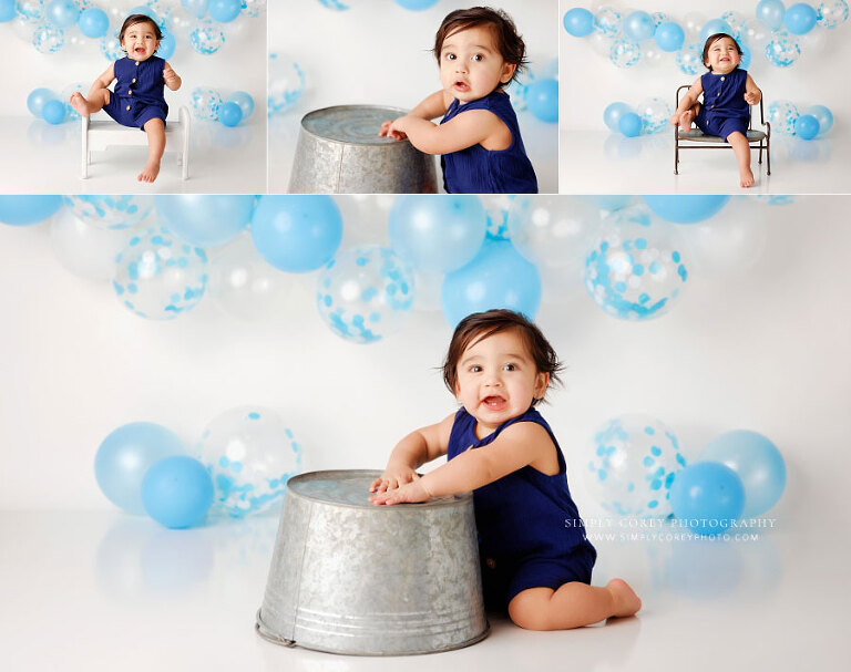 baby photographer near Dallas, GA; boy with balloons and bucket in studio