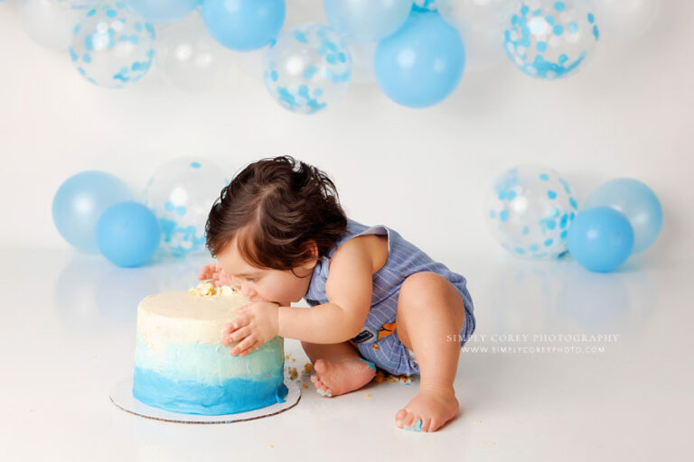 Atlanta cake smash photographer, baby with face in ombre blue cake on studio set