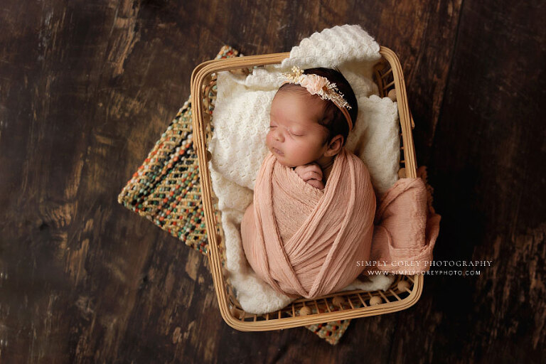 Bremen newborn photographer, baby girl with pink wrap in basket