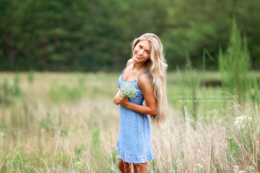 senior portrait photographer near Dallas, GA; teen in blue dress in tall grass