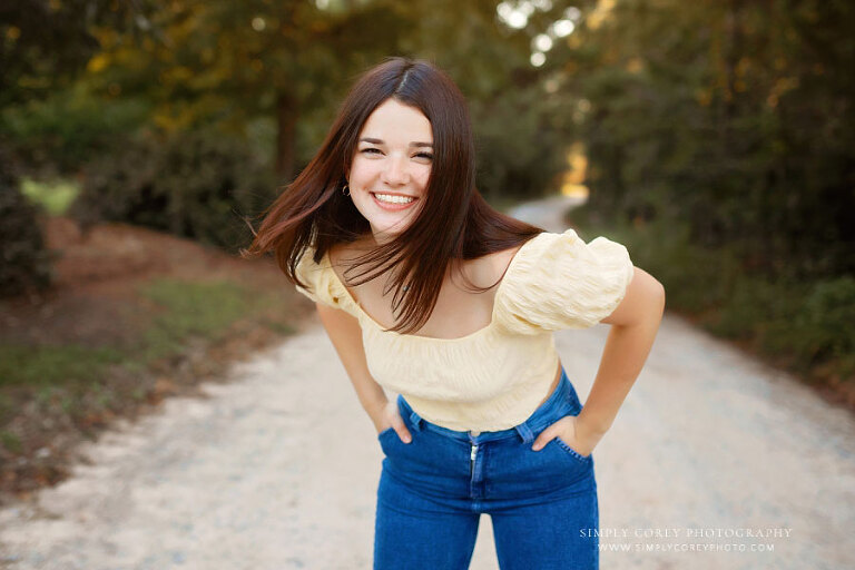 senior portrait photographer near Atlanta, teen girl outside on dirt road