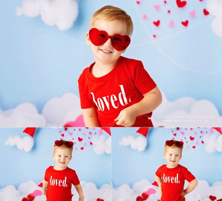 baby photographer near Newnan, toddler boy in red heart sunglasses for valentine studio session