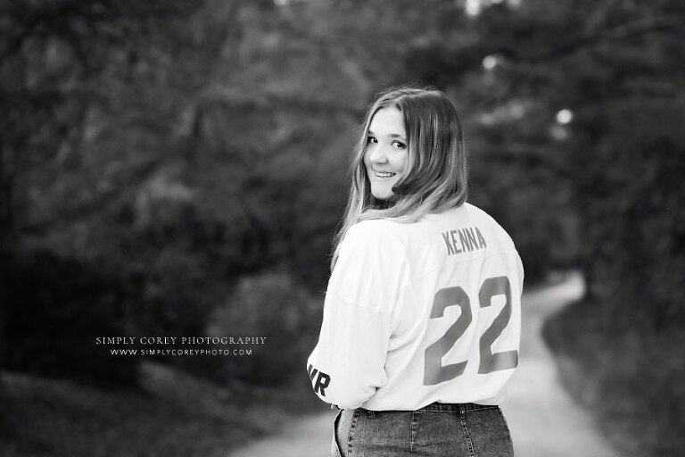 Hiram senior portrait photographer, teen girl outside in senior jersey