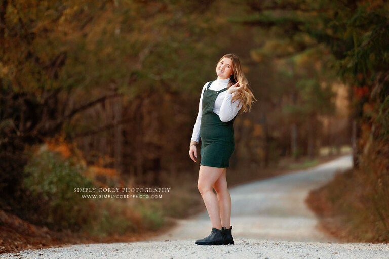 senior portrait photographer near Villa Rica, teen girl in green jumper outside