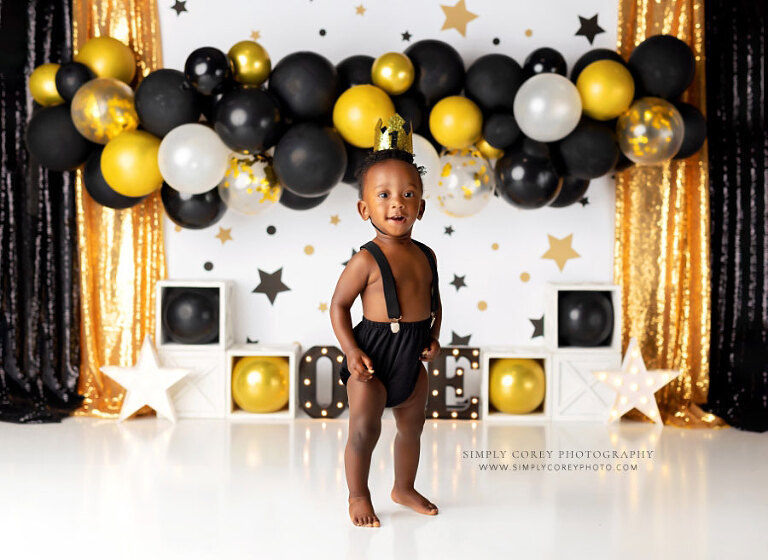 Atlanta baby photographer, boy in suspenders for Mr. Onederful cake smash