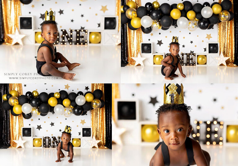 baby photographer near Douglasville, boy with black gold balloon garland in studio