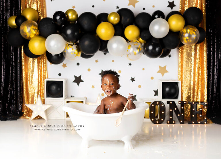 Atlanta cake smash photographer, baby in tub on black gold studio set with balloons