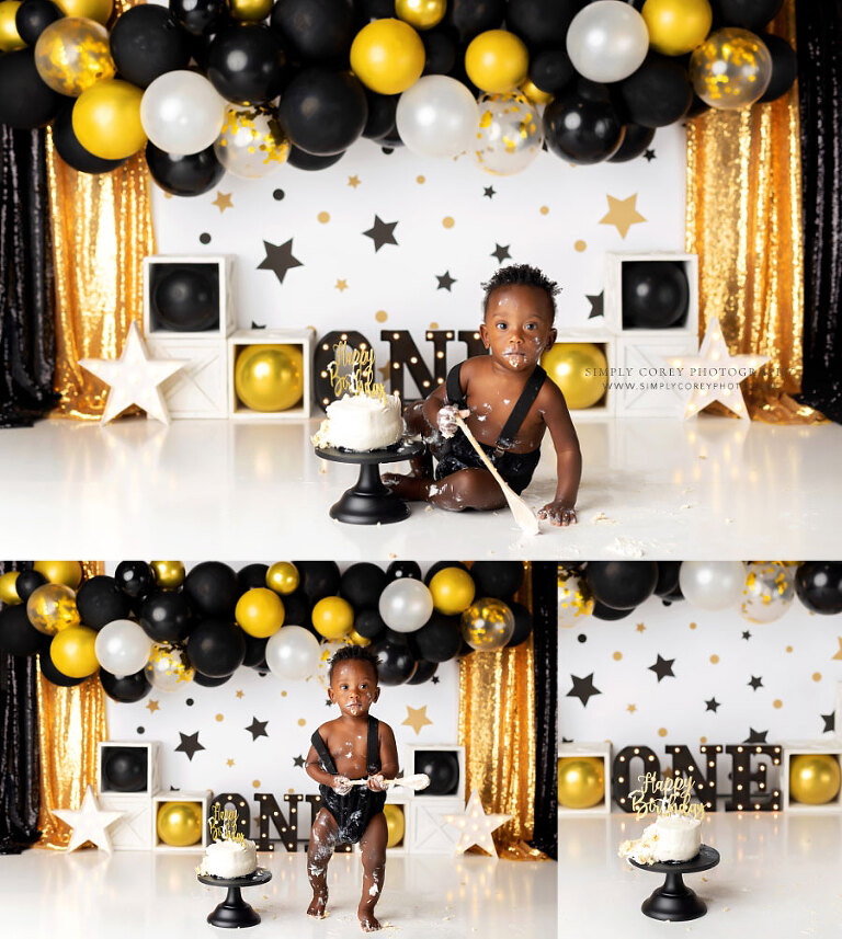cake smash photographer near Carrollton, GA; baby on black gold studio set with balloons