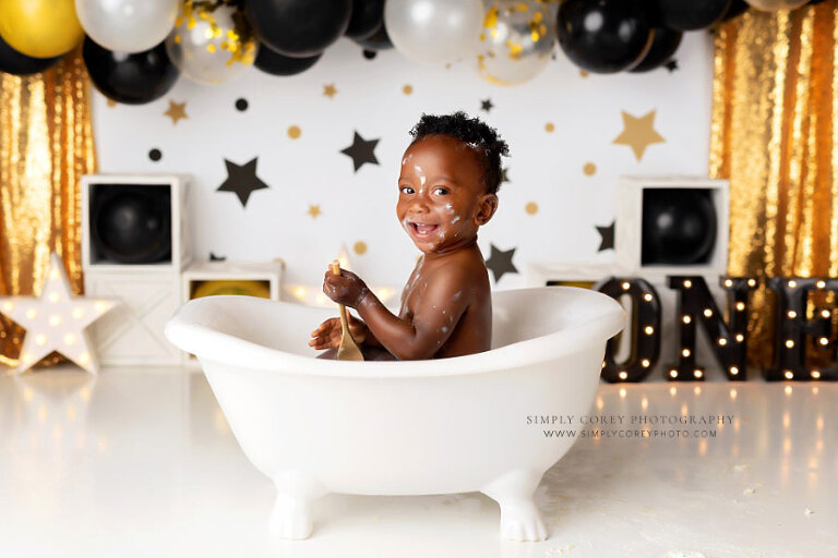 Tyrone baby photographer, boy in tub on black gold cake smash set