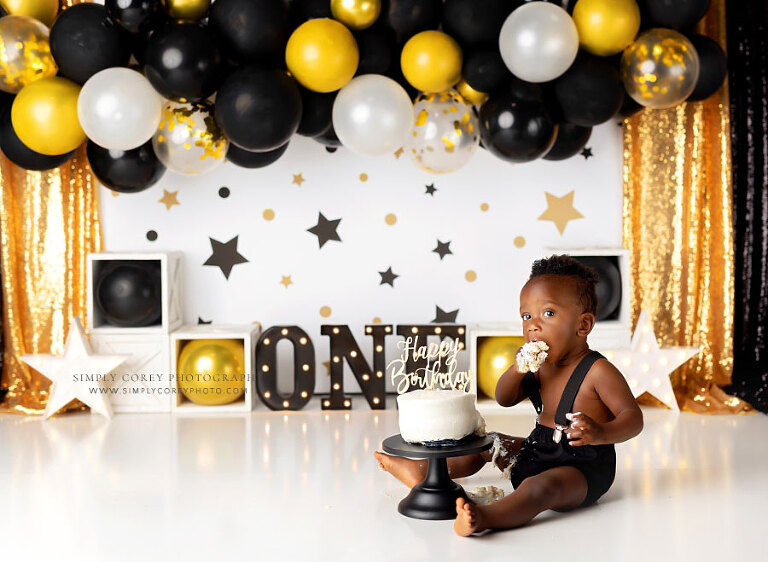 Tyrone cake smash photographer, baby with black and gold Mr Onederful studio set