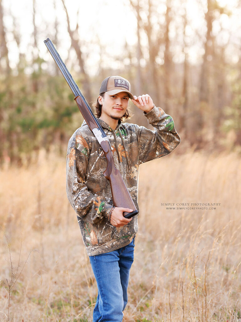 Newnan senior portrait photographer, teen boy outside in field with hunting rifle