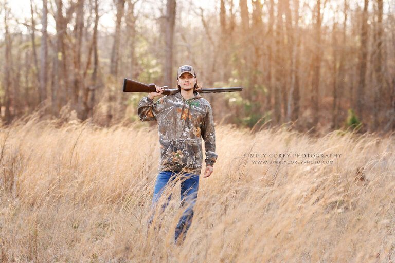 Villa Rica senior portrait photographer, teen boy outside in field with hunting rifle