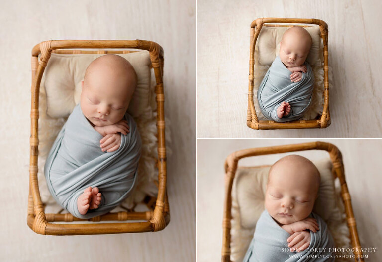 newborn photographer near Bremen, baby boy in blue swaddle with rattan boho bed