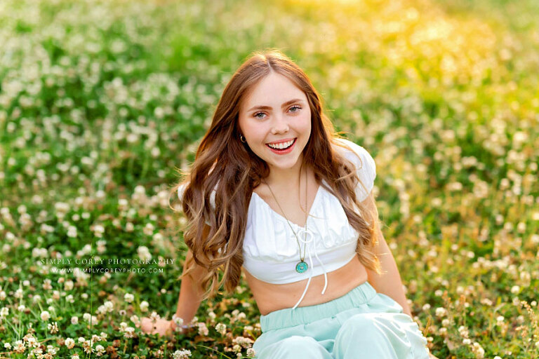 Tyrone senior portrait photographer, teen girl outside in grass and clover