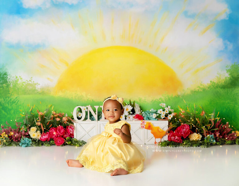 Douglasville baby photographer, girl on sunshine backdrop with flowers