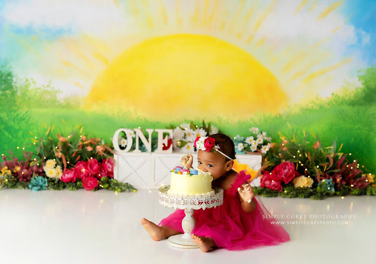 cake smash photographer near Atlanta, baby eating cake face first on sunshine set