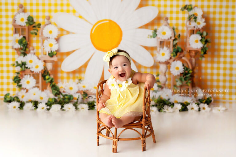 baby photographer near Tyrone, studio milestone session on yellow set with daisies