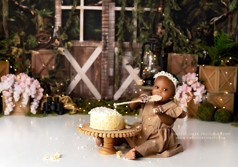 Atlanta cake smash photographer, baby girl with wooden spoon on explorer studio set