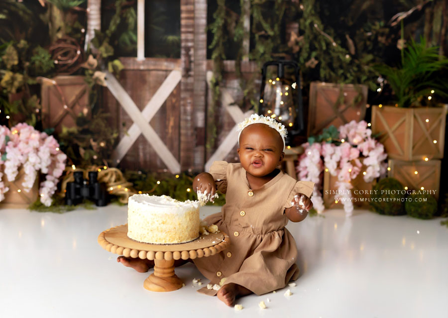 Newnan cake smash photographer, baby girl making funny face on explorer studio set