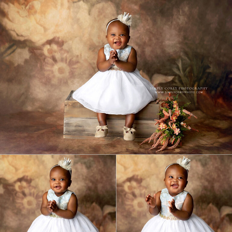 Villa Rica baby photographer, one year old in crown on floral backdrop