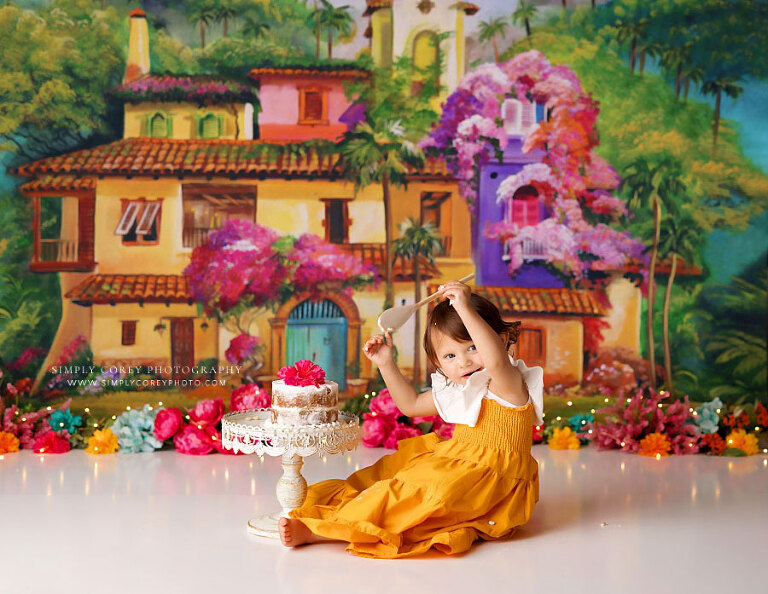 Newnan cake smash photographer, baby girl with wooden spoon on la casita studio theme