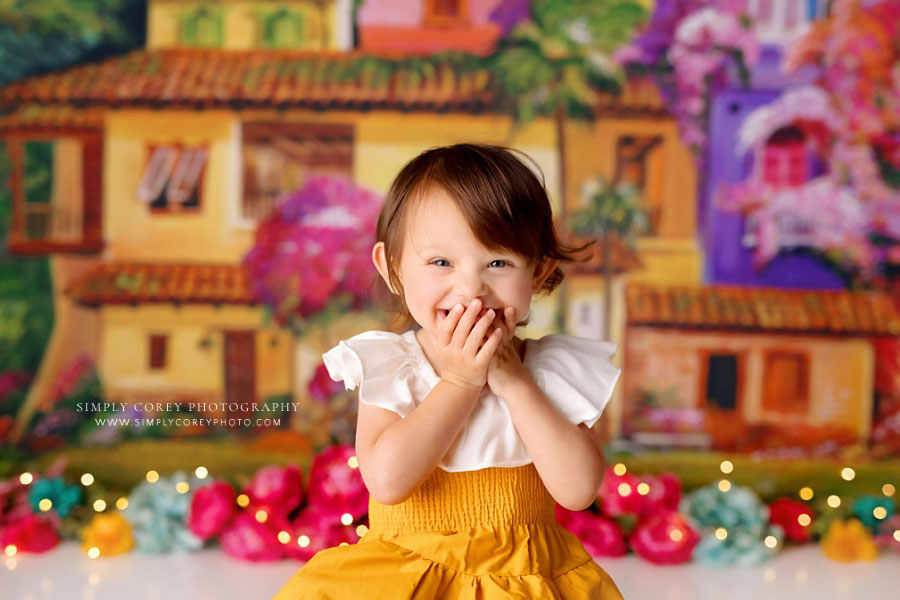 Villa Rica baby photographer, girl giggling on La Casita studio set