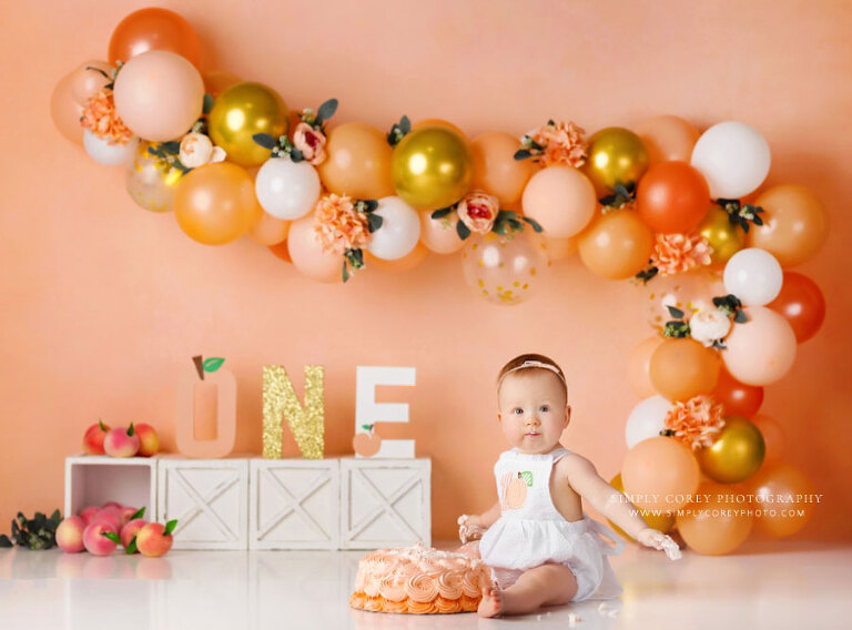 Atlanta cake smash photographer, peach studio theme with balloon garland 