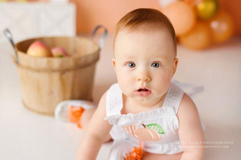 West Georgia baby photographer, girl in peach romper for first birthday