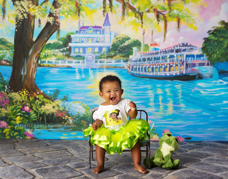 Atlanta baby photographer, girl with Princess Tiana dress and frog on bayou backdrop