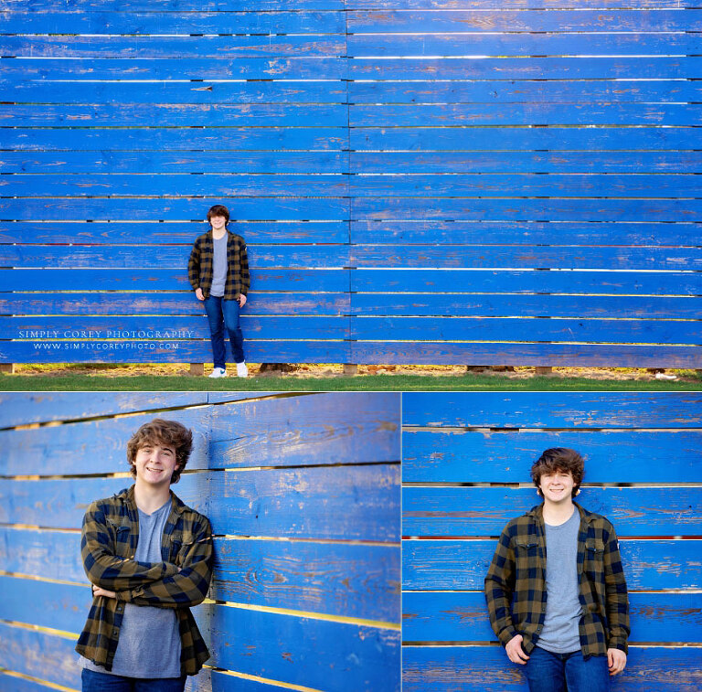 Lithia Springs senior portrait photographer, teen outside near blue wooden wall