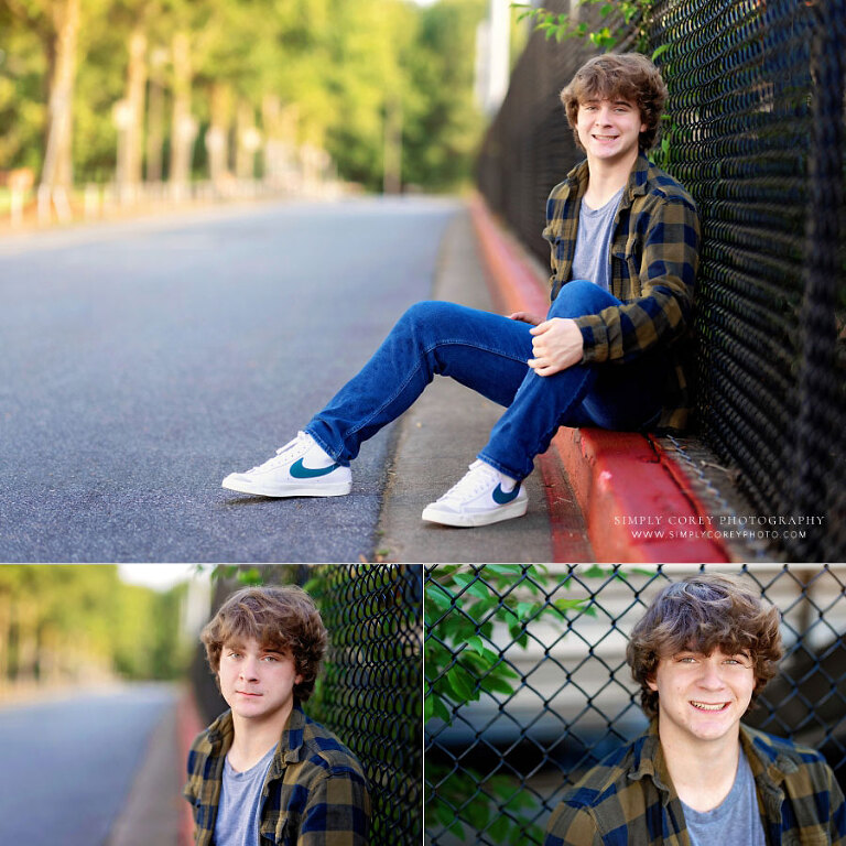 Tyrone senior portrait photographer, teen outside by chain link fence