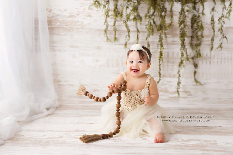 Atlanta baby photographer, boho milestone session with wooden beads and greenery