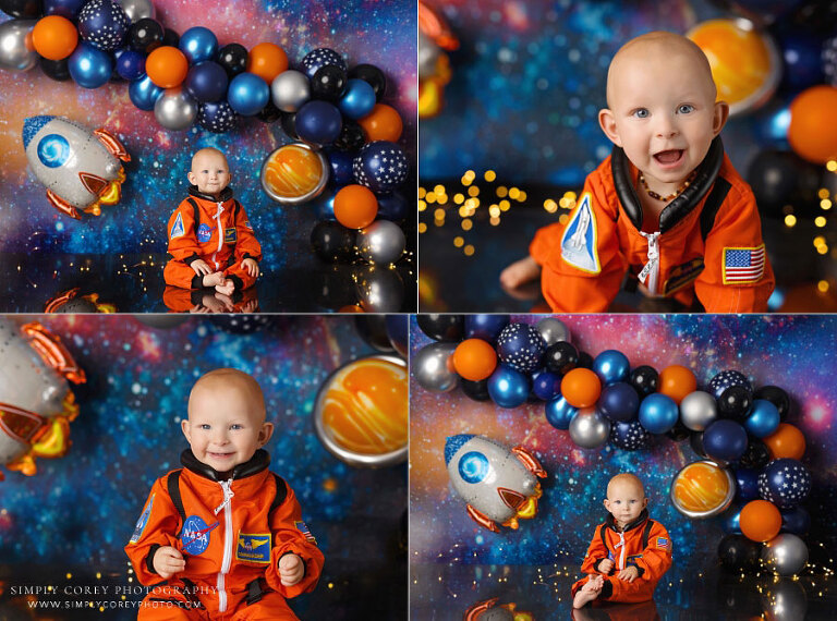 Tyrone baby photographer, boy in orange astronaut suit on outer space studio set