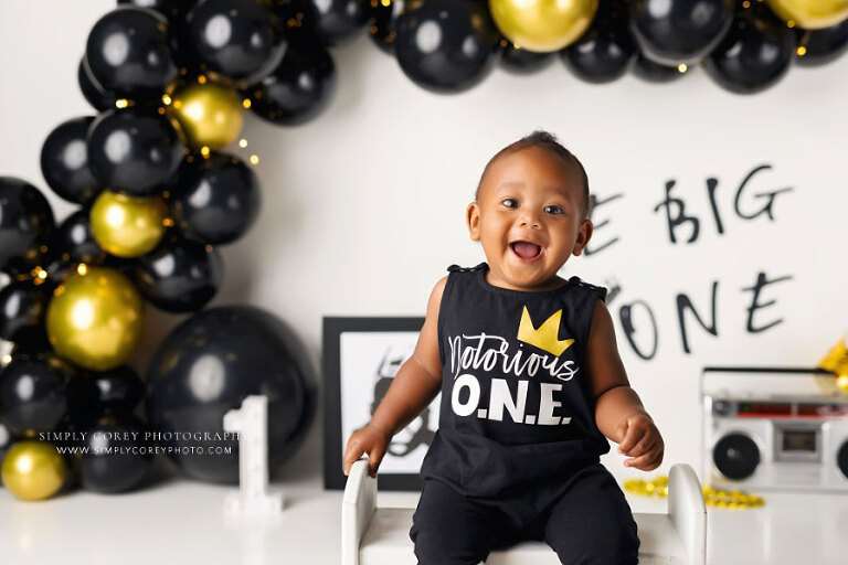 Newnan baby photographer, boy with big smile and Notorious One studio milestone theme