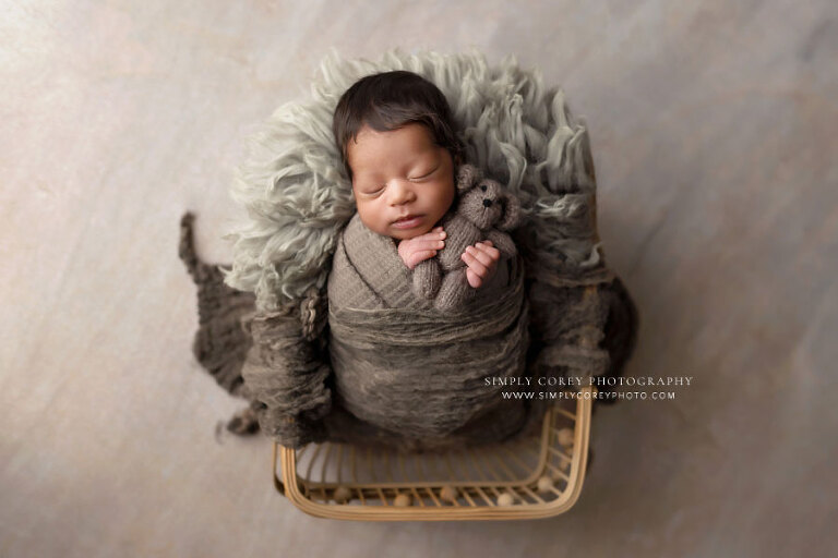 newborn photographer near Newnan, baby boy in basket with brown swaddle set and bear