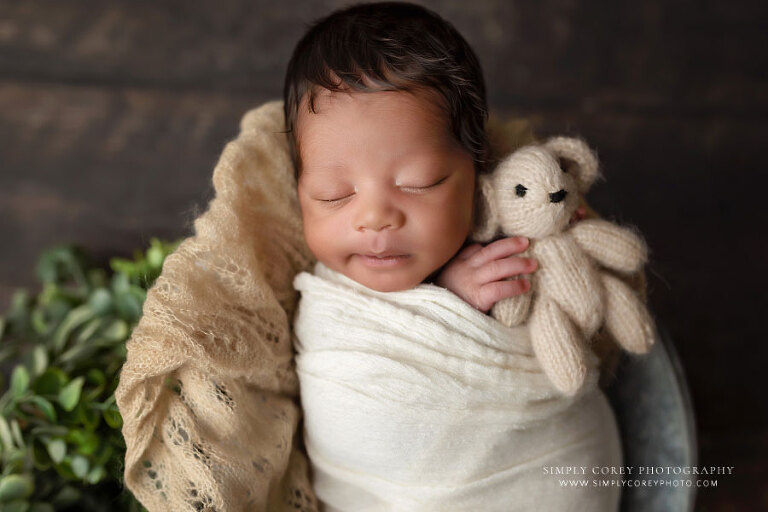 newborn photographer near Villa Rica, smiling baby boy holding teddy bear