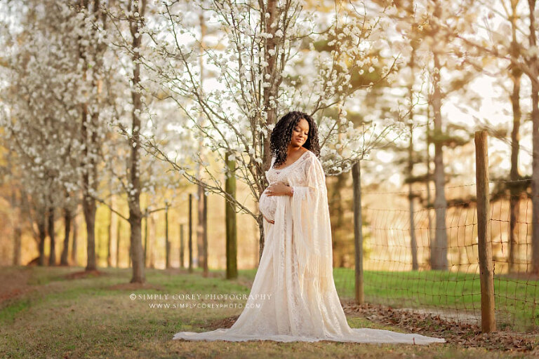 maternity photographer near Atlanta, outdoor portrait with boho dress by spring trees