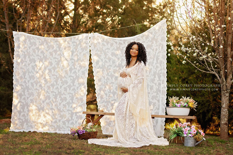 maternity photographer near Newnan, outdoor boho set with lace curtains in spring