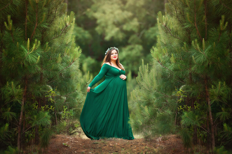 Newnan maternity photographer, outdoor portrait in green dress by pine trees